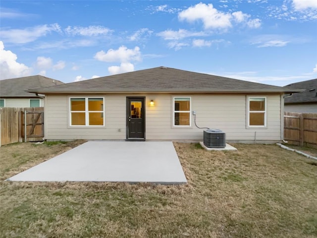 back of house with a yard and central AC unit