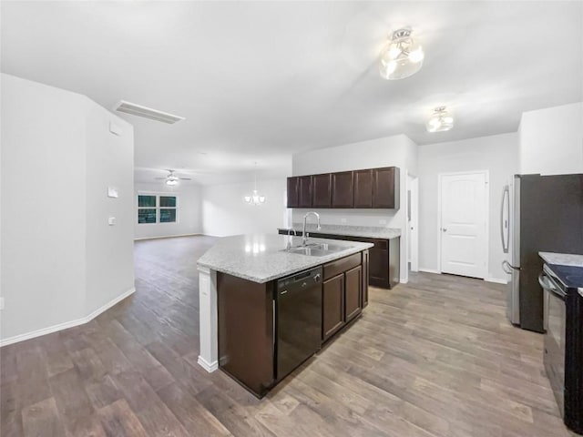 kitchen featuring ceiling fan, sink, black dishwasher, an island with sink, and dark brown cabinets