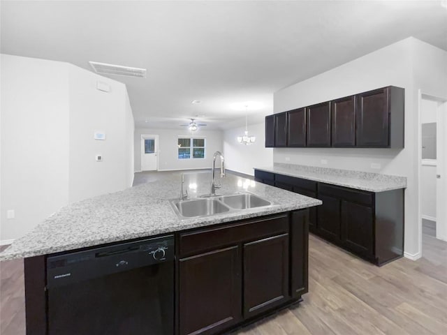 kitchen with a kitchen island with sink, sink, ceiling fan, black dishwasher, and decorative light fixtures