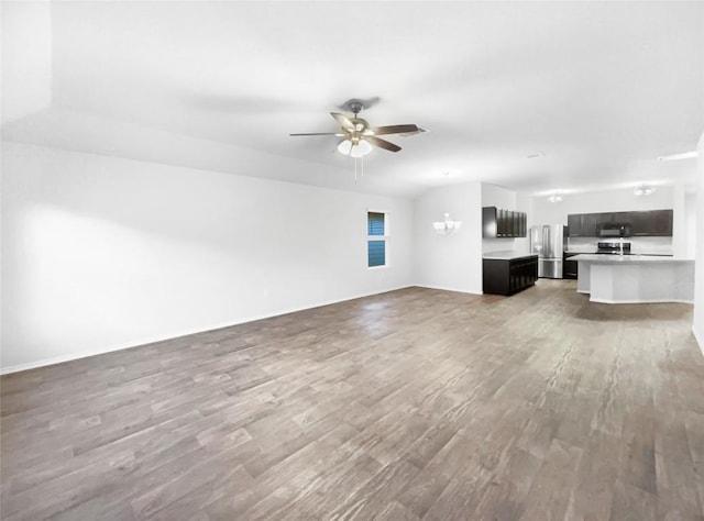 unfurnished living room with hardwood / wood-style flooring and ceiling fan