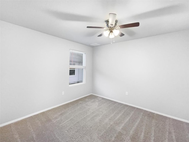 spare room featuring ceiling fan and carpet floors