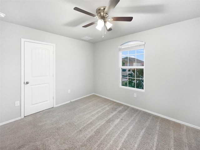 spare room featuring ceiling fan and carpet floors