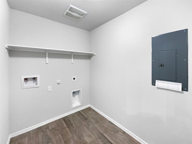 washroom with dark wood-type flooring, washer hookup, electric dryer hookup, electric panel, and gas dryer hookup