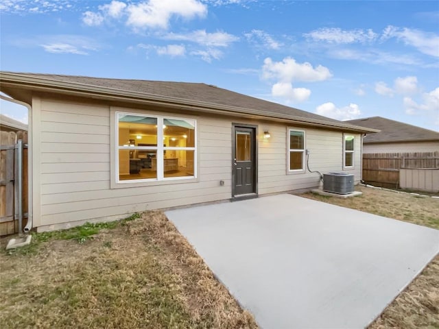 rear view of property with a patio area and central air condition unit