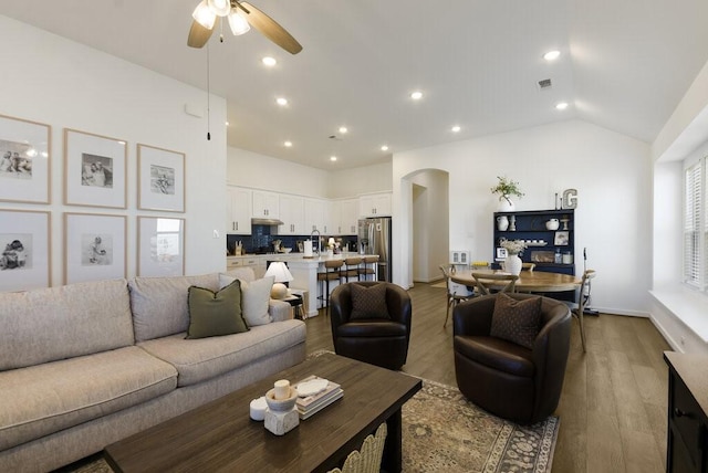 524 Calmo Ct, Liberty Hill, TX 78642 - living room featuring arched walkways, ceiling fan, wood finished floors, recessed lighting, and vaulted ceiling