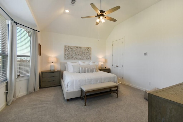 carpeted bedroom with ceiling fan, vaulted ceiling, and a closet