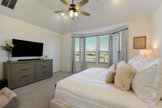 carpeted bedroom featuring high vaulted ceiling and ceiling fan