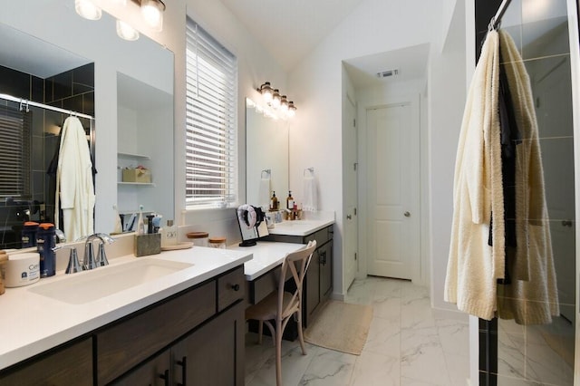 bathroom with vanity and lofted ceiling