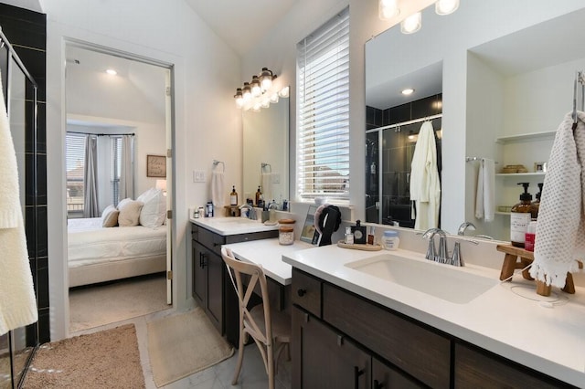 bathroom with a shower with door, vaulted ceiling, and vanity