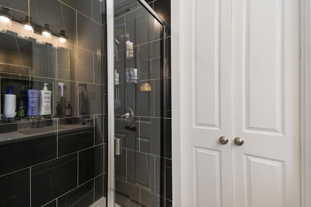 bathroom featuring a shower with door