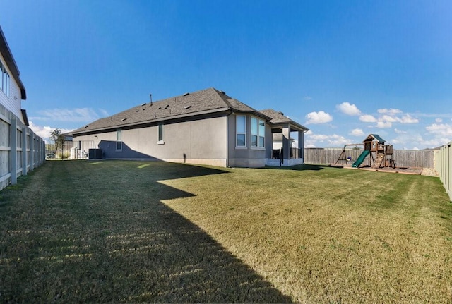 view of yard with cooling unit and a playground