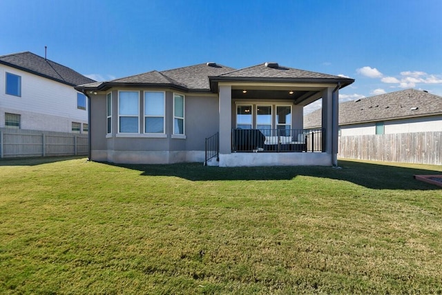 rear view of house with a yard