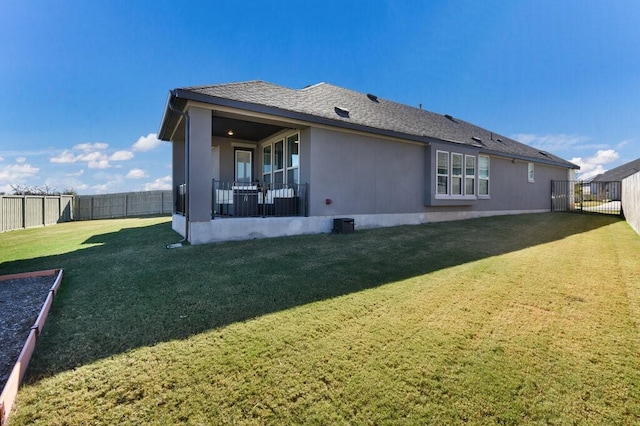 rear view of house with a yard