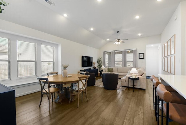 dining room with hardwood / wood-style flooring, vaulted ceiling, and ceiling fan