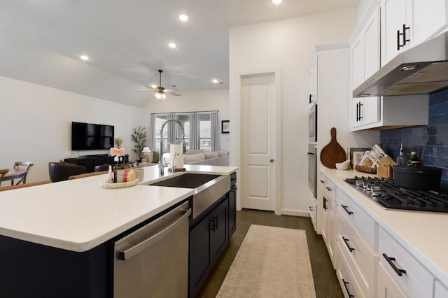 kitchen featuring sink, white cabinetry, a center island with sink, appliances with stainless steel finishes, and ceiling fan