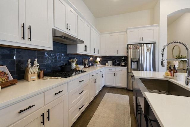 kitchen with tasteful backsplash, gas stovetop, dark hardwood / wood-style flooring, and white cabinets