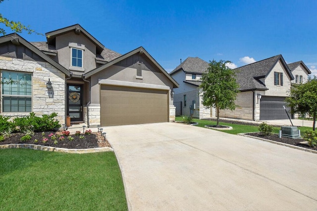 524 Calmo Ct, Liberty Hill, TX 78642 - view of front of house with stone siding, stucco siding, concrete driveway, a garage, and a front lawn
