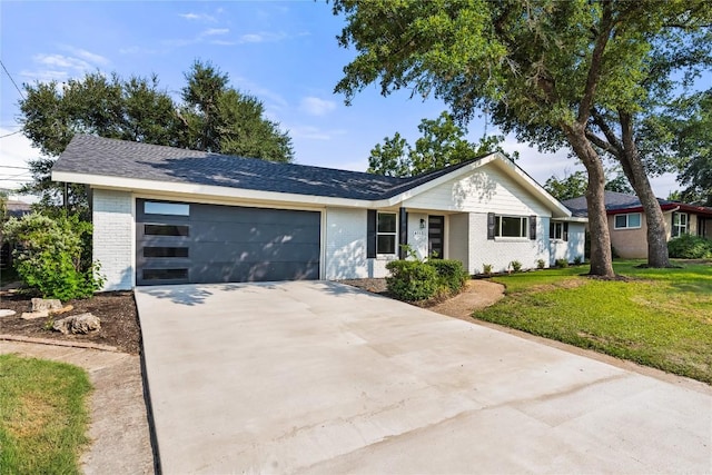 single story home with a garage and a front lawn