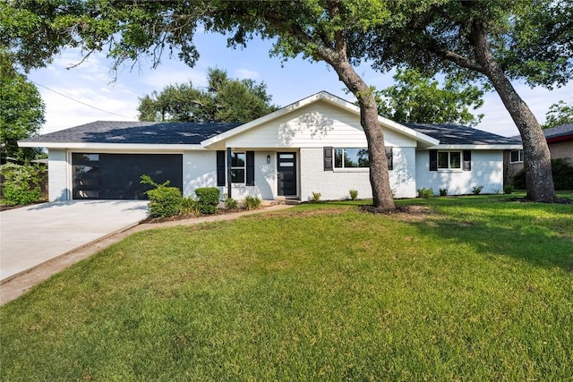 single story home with a front yard and a garage