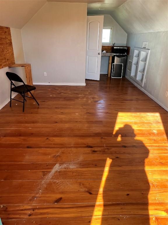 bonus room featuring hardwood / wood-style floors and lofted ceiling