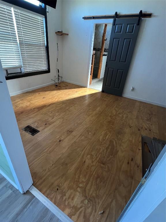 interior space featuring a barn door and hardwood / wood-style flooring