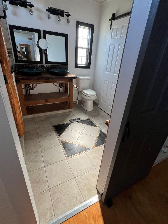 bathroom with tile patterned flooring, toilet, and sink