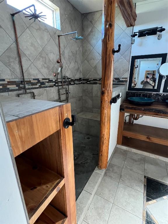 bathroom featuring a tile shower and tile patterned floors