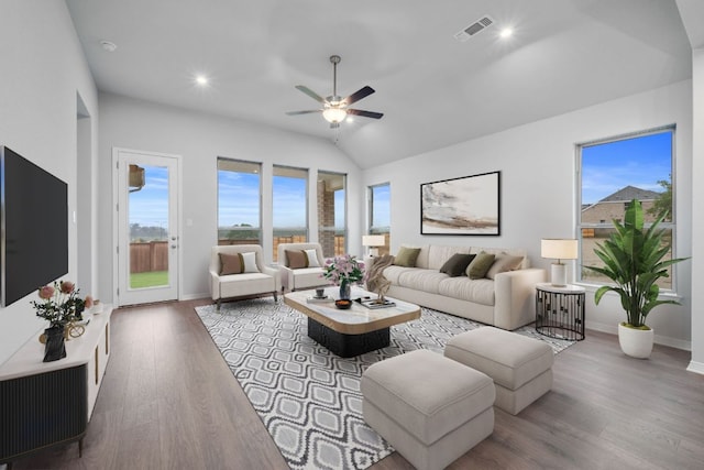 409 Raleigh Dr, Georgetown, TX 78633 - living room featuring plenty of natural light, a ceiling fan, wood finished floors, baseboards, and vaulted ceiling