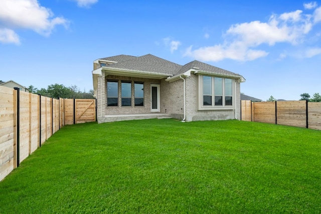 409 Raleigh Dr, Georgetown, TX 78633 - back of house featuring a fenced backyard, brick siding, and a shingled roof