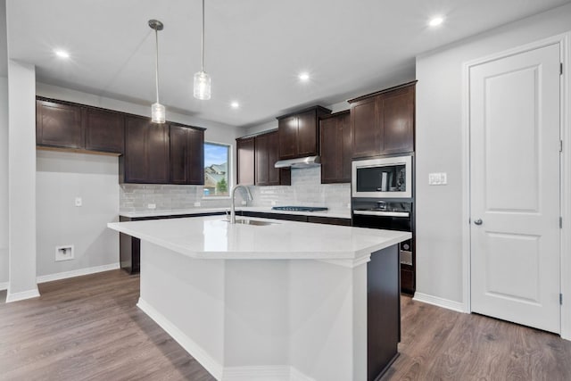 409 Raleigh Dr, Georgetown, TX 78633 - kitchen featuring black appliances, wood finished floors, tasteful backsplash, dark brown cabinets, and recessed lighting