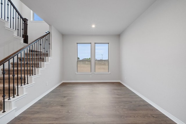 409 Raleigh Dr, Georgetown, TX 78633 - unfurnished living room featuring dark wood-type flooring, stairway, and recessed lighting