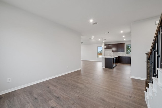 409 Raleigh Dr, Georgetown, TX 78633 - unfurnished living room with stairway, recessed lighting, and dark wood-style floors