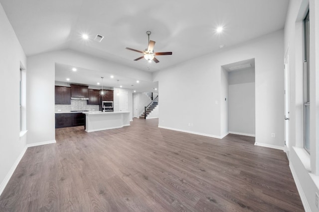 409 Raleigh Dr, Georgetown, TX 78633 - unfurnished living room featuring a ceiling fan, recessed lighting, dark wood-style floors, lofted ceiling, and stairway