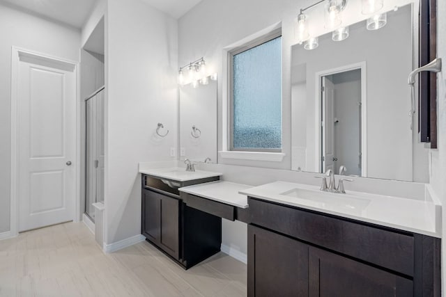 409 Raleigh Dr, Georgetown, TX 78633 - bathroom with a stall shower, vanity, and baseboards