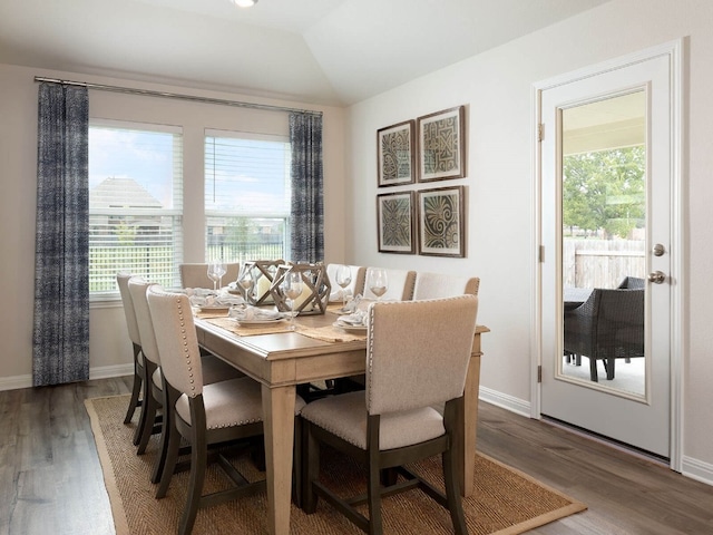 dining space featuring dark hardwood / wood-style floors and lofted ceiling