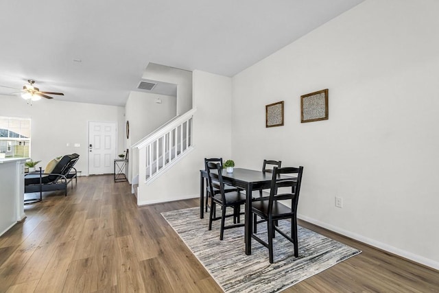 dining room with dark hardwood / wood-style flooring and ceiling fan