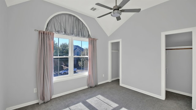 unfurnished bedroom featuring ceiling fan, a closet, carpet floors, and vaulted ceiling