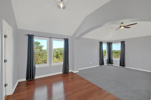 spare room featuring ceiling fan, dark hardwood / wood-style flooring, and lofted ceiling