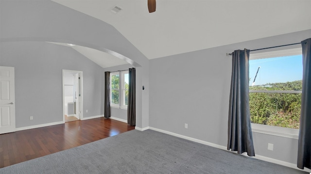 spare room featuring dark wood-type flooring, ceiling fan, and lofted ceiling