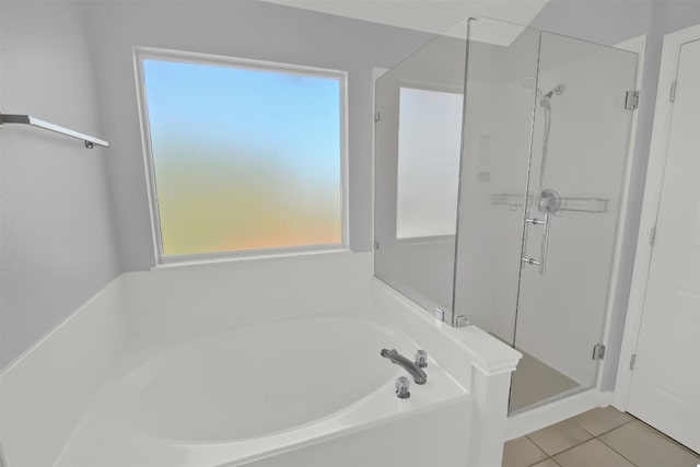 bathroom with tile patterned flooring and separate shower and tub