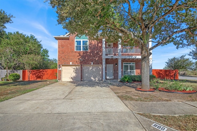 view of front of home with a balcony, a front lawn, and a garage