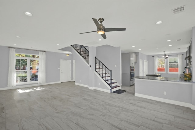 unfurnished living room featuring ceiling fan