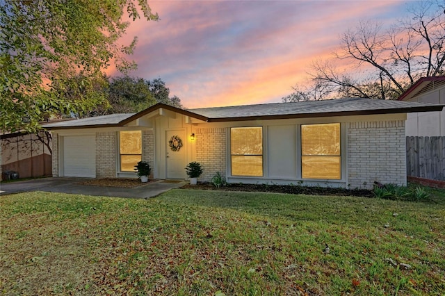 single story home with a yard and a garage