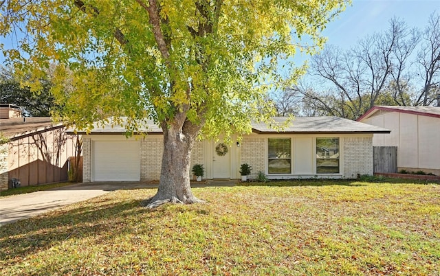 ranch-style house with a garage and a front lawn