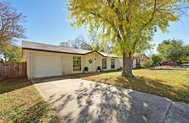 ranch-style home with a front yard and a garage