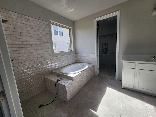 full bathroom with tiled shower, a garden tub, vanity, and tile patterned floors