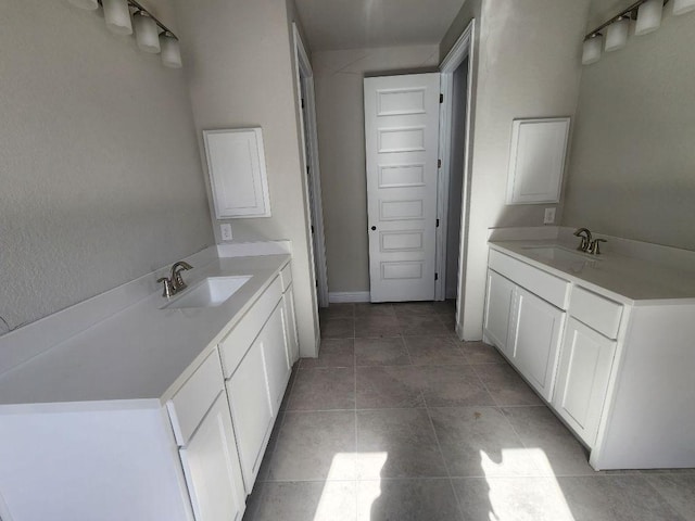 bathroom featuring two vanities and a sink