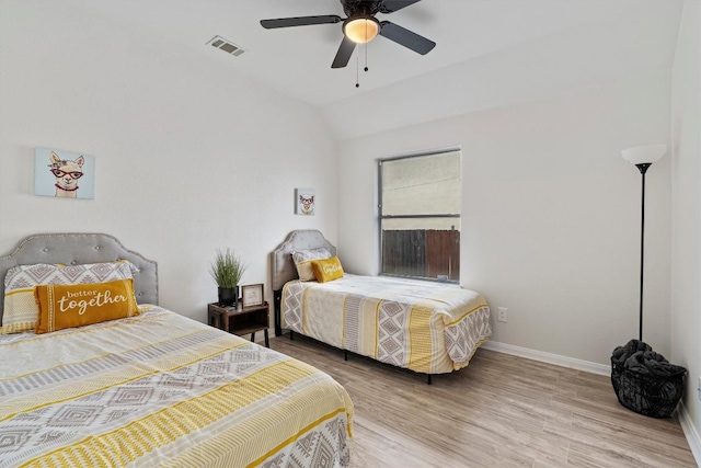 bedroom with hardwood / wood-style flooring, ceiling fan, and vaulted ceiling