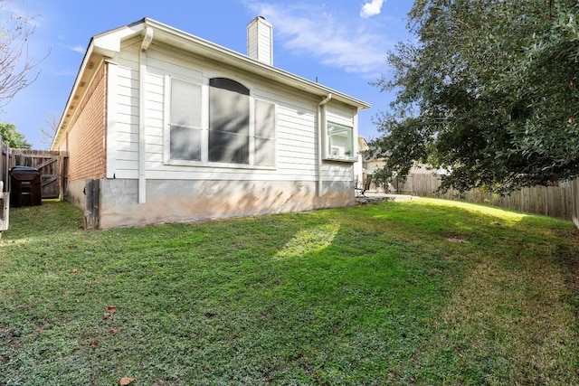 view of side of home featuring a yard