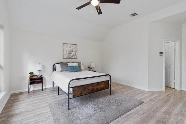 bedroom with ceiling fan, light wood-type flooring, and lofted ceiling